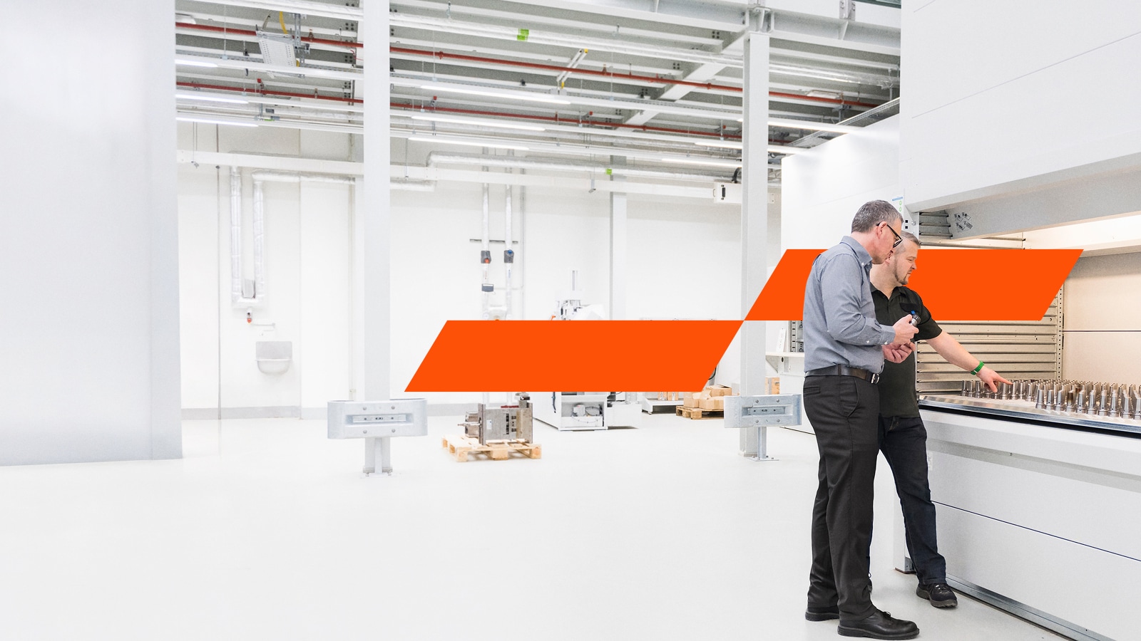 Two men speaking in a factory